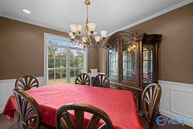 dining space with an inviting chandelier and ornamental molding