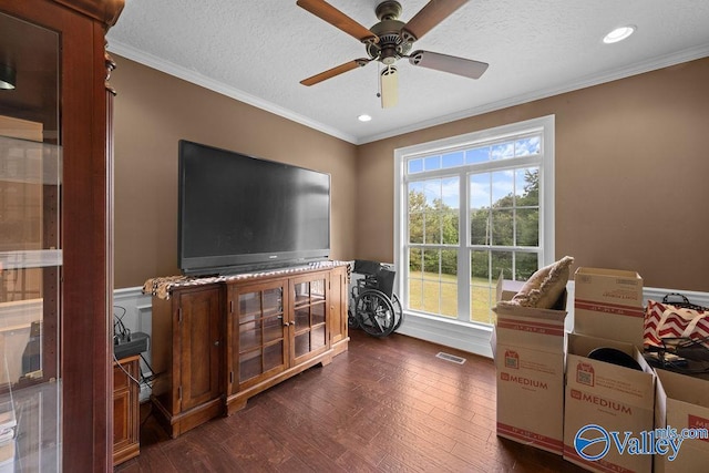 interior space featuring ornamental molding, dark wood-type flooring, and a textured ceiling