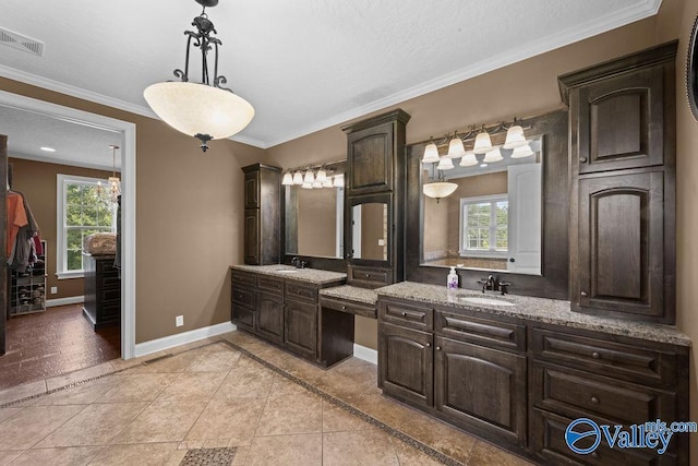 bathroom featuring tile patterned flooring, crown molding, and vanity