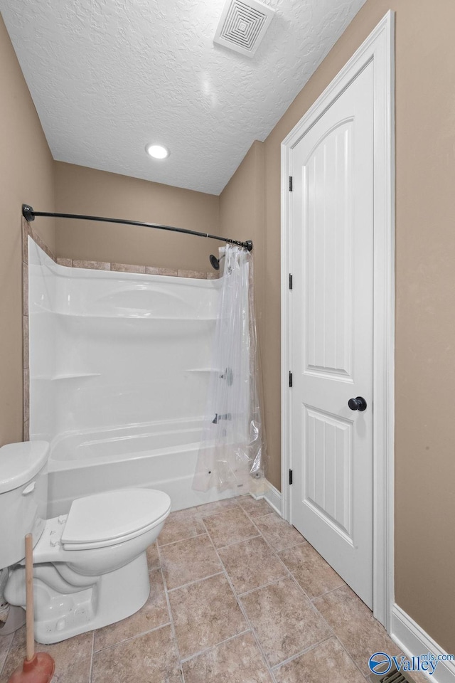 bathroom featuring toilet and a textured ceiling