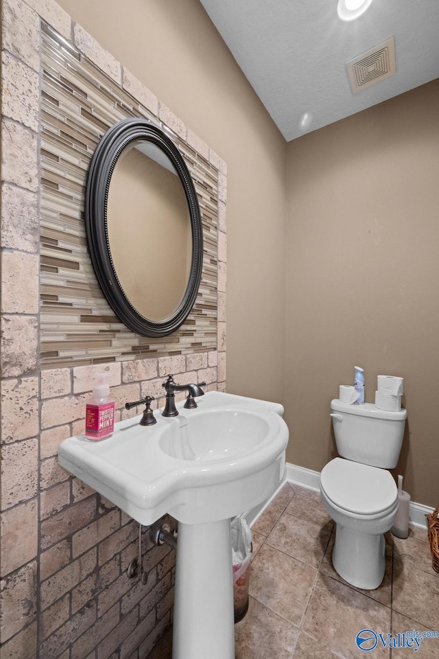 bathroom with tile patterned flooring and toilet