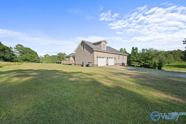 view of side of home featuring a wooden deck, a yard, and a garage