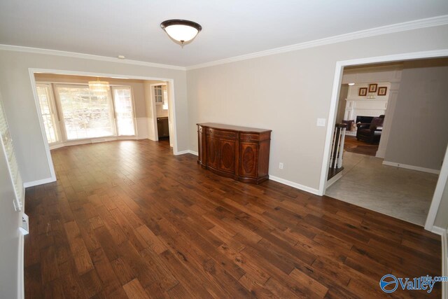 unfurnished room featuring dark hardwood / wood-style flooring and crown molding