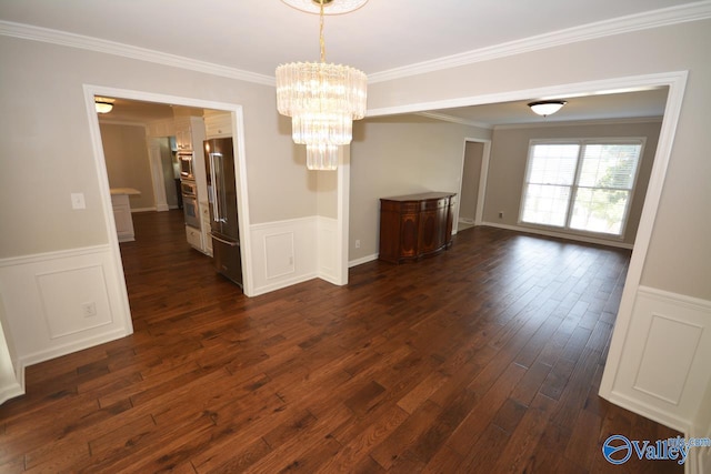 unfurnished dining area with ornamental molding, dark hardwood / wood-style flooring, and an inviting chandelier