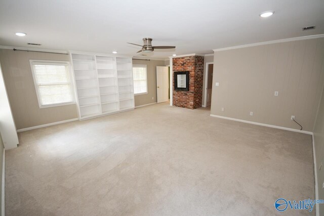 unfurnished living room with a fireplace, crown molding, light colored carpet, and ceiling fan