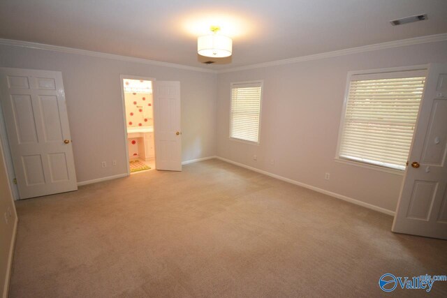 unfurnished bedroom with light colored carpet, connected bathroom, and ornamental molding