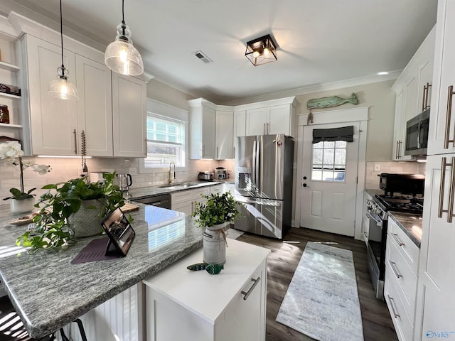 kitchen with visible vents, black appliances, a sink, a peninsula, and white cabinets