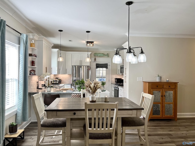 dining space featuring a wealth of natural light, crown molding, and dark wood-style flooring