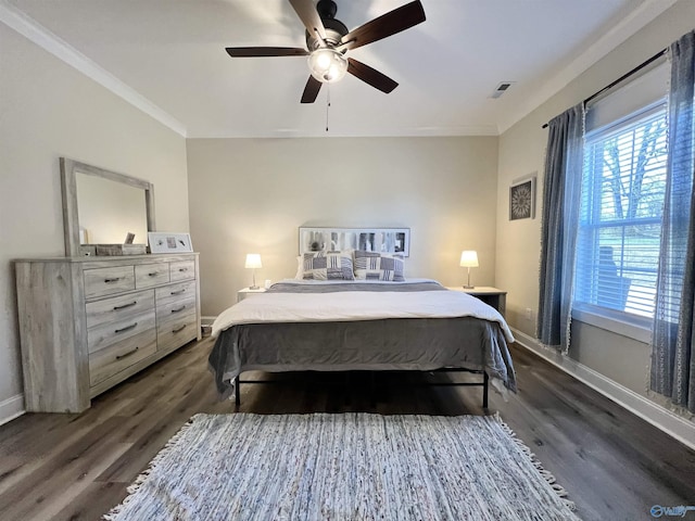 bedroom with visible vents, baseboards, dark wood-type flooring, and crown molding