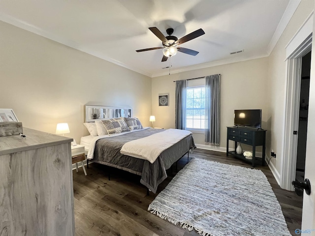 bedroom featuring visible vents, baseboards, dark wood finished floors, and ornamental molding