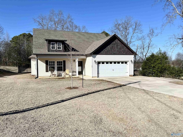 view of front of property featuring concrete driveway, an attached garage, and a shingled roof