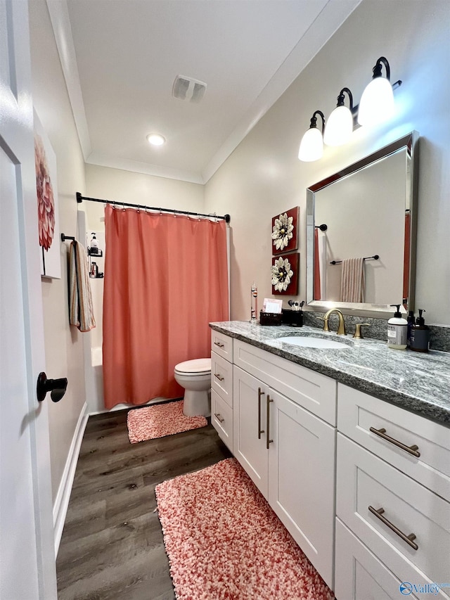 bathroom featuring vanity, a shower with curtain, wood finished floors, visible vents, and toilet