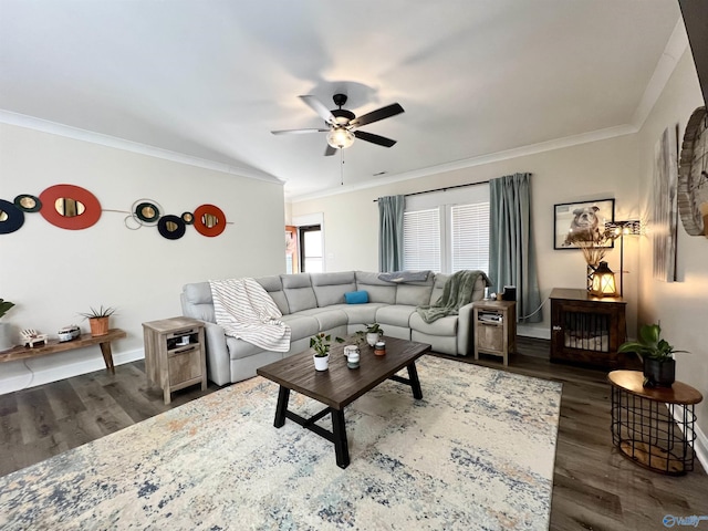 living area with baseboards, wood finished floors, a ceiling fan, and ornamental molding