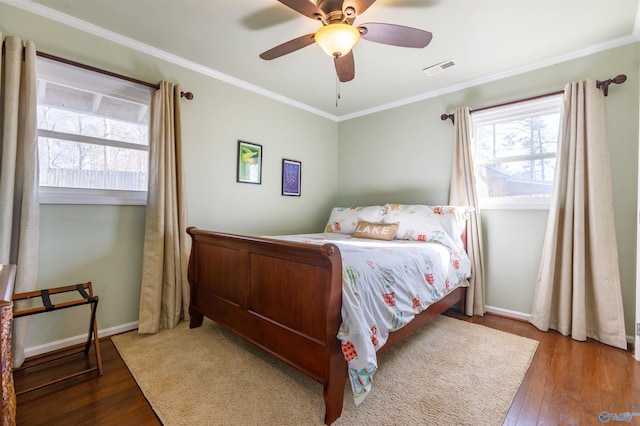 bedroom with ceiling fan, ornamental molding, and dark hardwood / wood-style floors