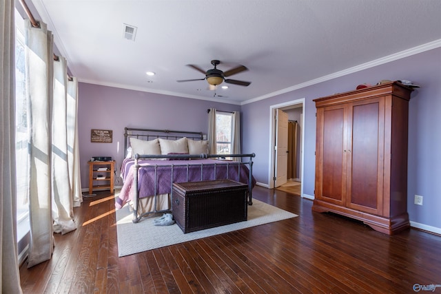 bedroom featuring ceiling fan, dark hardwood / wood-style floors, and crown molding