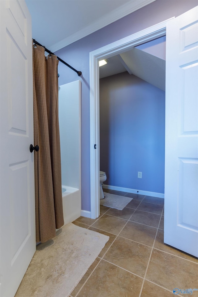 bathroom featuring tile patterned floors, toilet, ornamental molding, and shower / bath combo