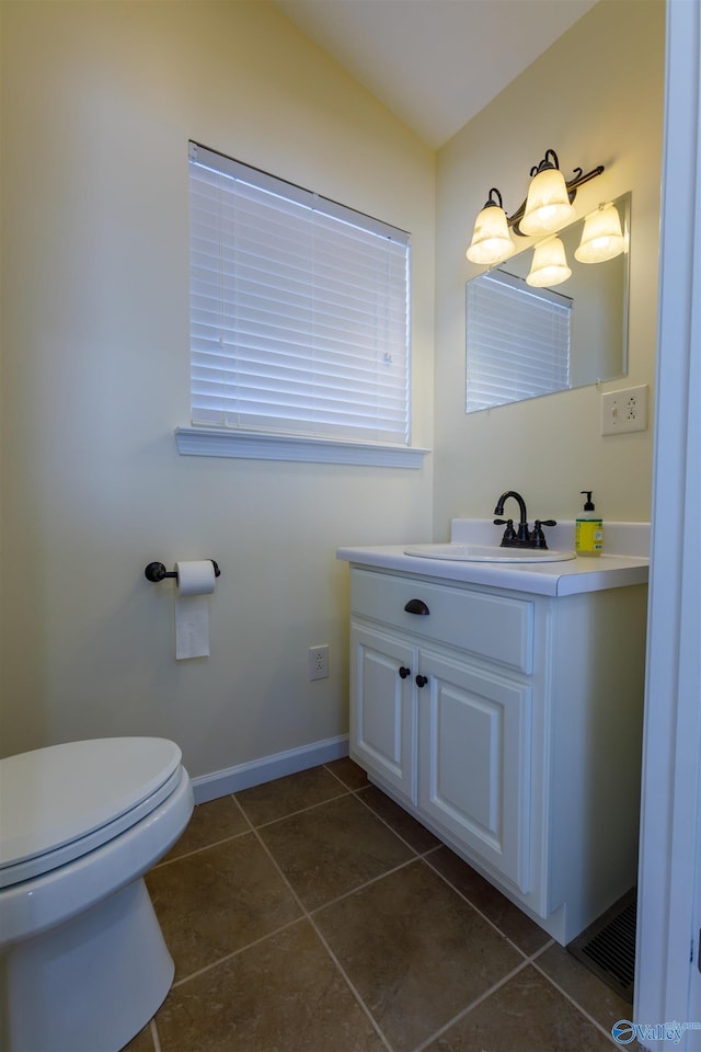 bathroom featuring toilet, tile patterned floors, and vanity