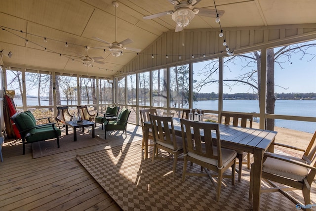 sunroom featuring ceiling fan, lofted ceiling, and a water view