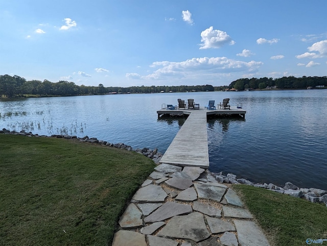 dock area featuring a lawn and a water view