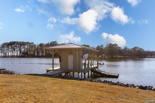 dock area featuring a lawn and a water view