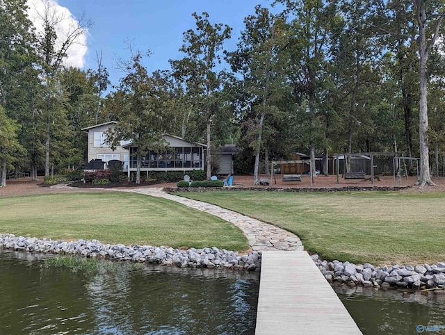 dock area featuring a lawn and a water view