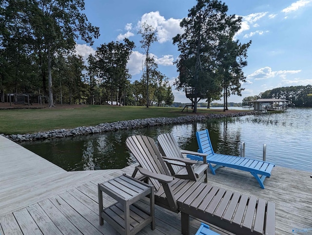 view of dock featuring a water view and a yard