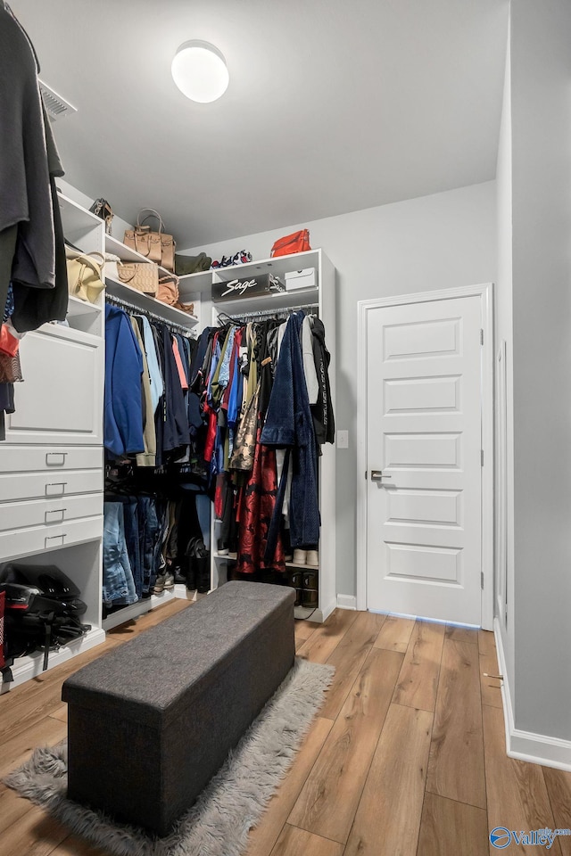 walk in closet with wood-type flooring