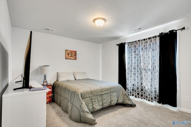 bedroom with visible vents and carpet flooring