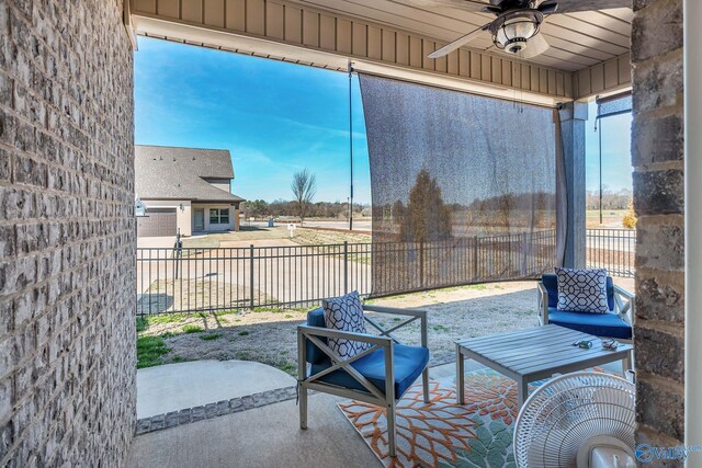 view of patio / terrace with ceiling fan and fence