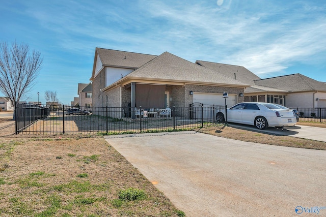 view of front facade with brick siding, roof with shingles, concrete driveway, an attached garage, and fence