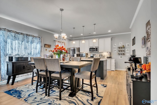 dining space featuring light wood-type flooring, ornamental molding, and a notable chandelier