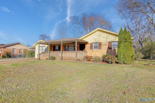 single story home featuring brick siding, a porch, and a front lawn