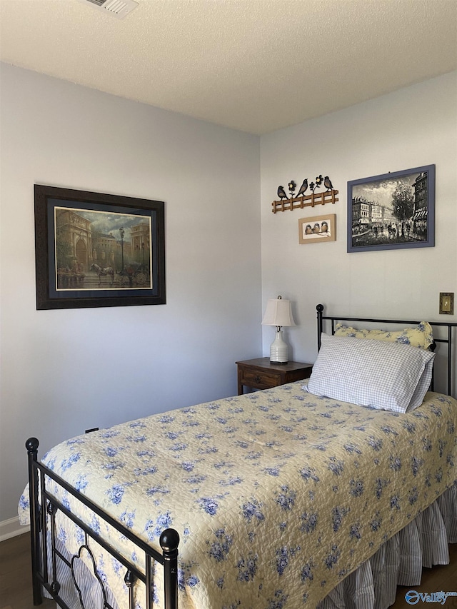 bedroom with baseboards and dark wood-style floors