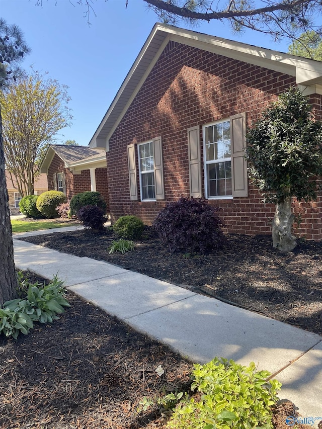 view of side of home featuring brick siding