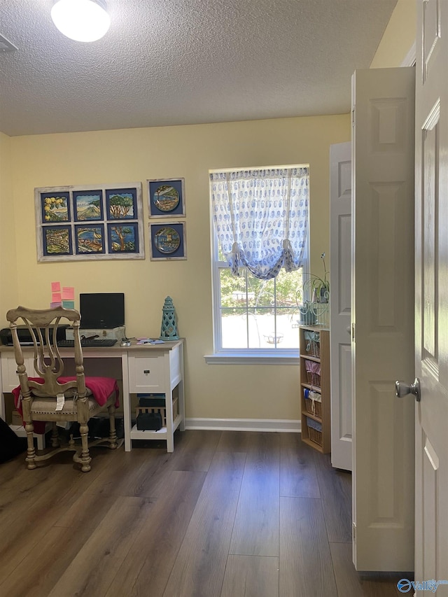 office with baseboards, a textured ceiling, and wood finished floors