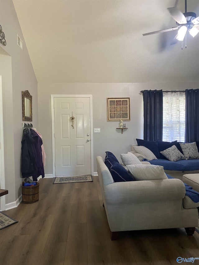 living room with ceiling fan, wood finished floors, and lofted ceiling