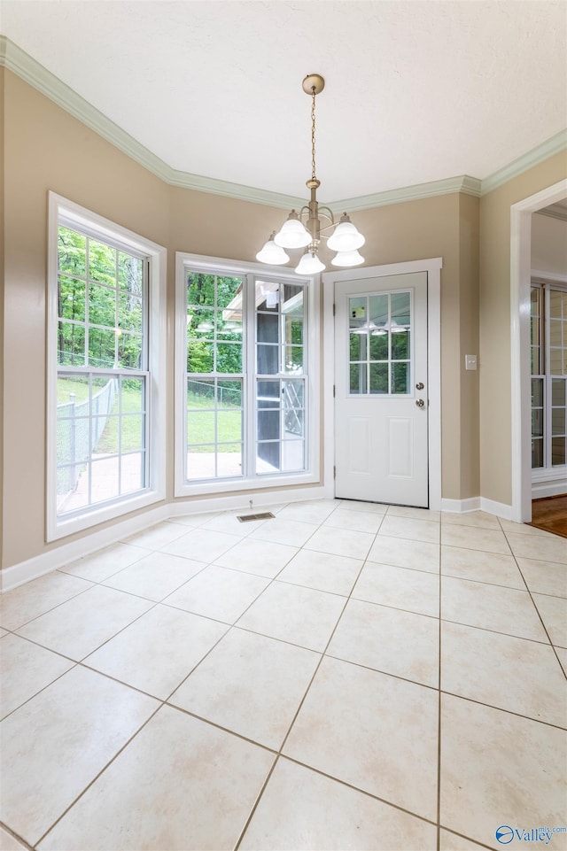 2115 James Dr, Southside, AL 35907 - unfurnished dining area with a chandelier, light tile patterned floors, healthy amount of natural light, ornamental molding, and baseboards
