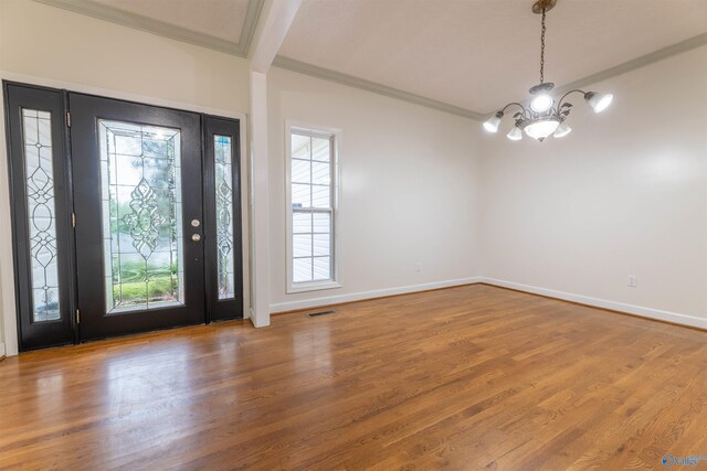 2115 James Dr, Southside, AL 35907 - foyer entrance with a chandelier, ornamental molding, wood finished floors, and baseboards