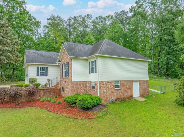 2115 James Dr, Southside, AL 35907 - view of home's exterior featuring brick siding and a shingled roof