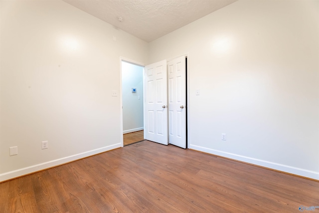 2115 James Dr, Southside, AL 35907 - unfurnished room with baseboards, wood finished floors, and a textured ceiling