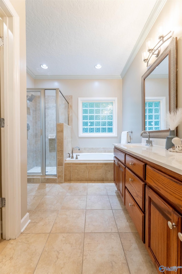 2115 James Dr, Southside, AL 35907 - bathroom featuring ornamental molding, a shower stall, a garden tub, vanity, and a textured ceiling