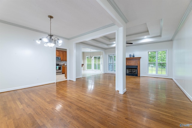 2115 James Dr, Southside, AL 35907 - unfurnished living room with a chandelier, crown molding, a fireplace, light wood-type flooring, and baseboards