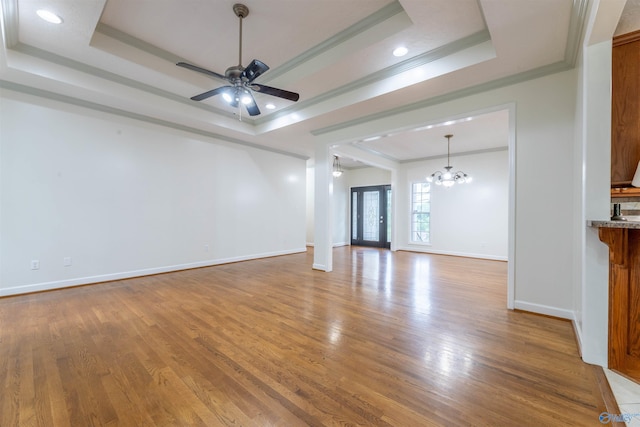2115 James Dr, Southside, AL 35907 - unfurnished living room featuring a raised ceiling, crown molding, wood finished floors, ceiling fan, and recessed lighting