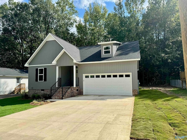 view of front of house featuring a garage and a front lawn