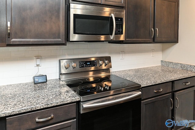 kitchen featuring dark brown cabinetry, stainless steel appliances, and backsplash