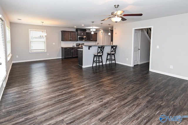 living room with baseboards, dark wood-type flooring, ceiling fan, and recessed lighting