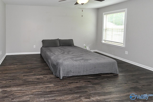 bedroom with baseboards, ceiling fan, and dark wood-style flooring