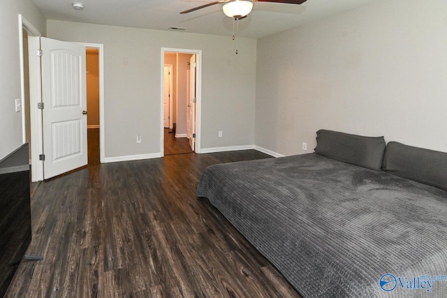 bedroom with baseboards, ceiling fan, wood finished floors, and visible vents