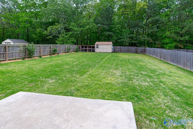 view of yard with a fenced backyard, an outdoor structure, a patio area, and a shed