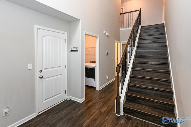 staircase featuring baseboards and wood finished floors